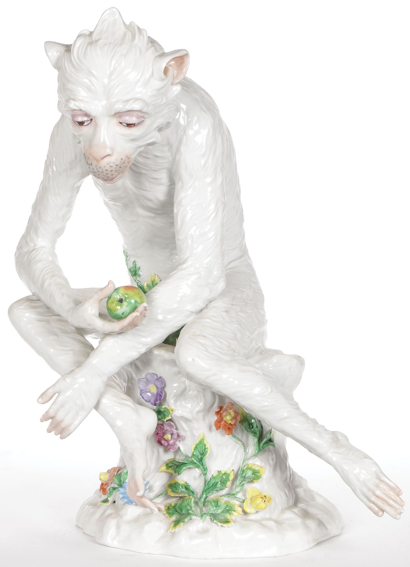 A DRESDEN PORCELAIN MONKEY, CARL THIEME: A DRESDEN PORCELAIN MONKEY, CARL THIEME. Finely modeled of good anatomy and proportions, seated on a stump with applied flowers and eating an apple. Interior with blue underglaze Dresden mark of Carl