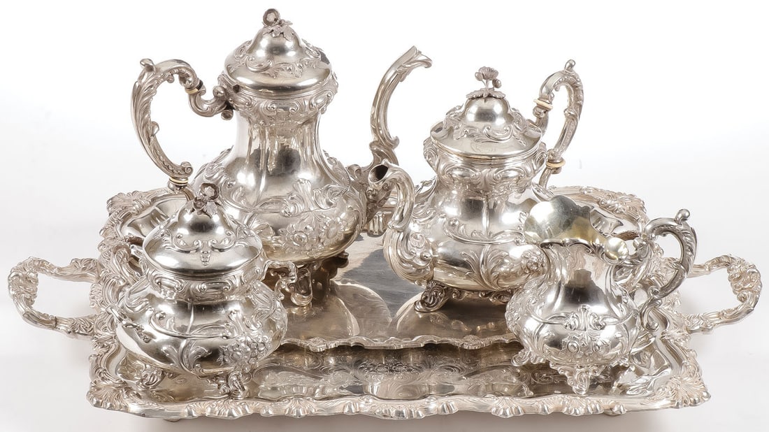 A BELGIAN FOUR PIECE SILVER SERVICE, 19TH C: A BELGIAN FOUR PIECE SILVER SERVICE, 19TH C. Comprising a Belgian four-piece matching coffee and tea pot together with a matching creamer and covered sugar, each heavily repoussed in the rococo style 
