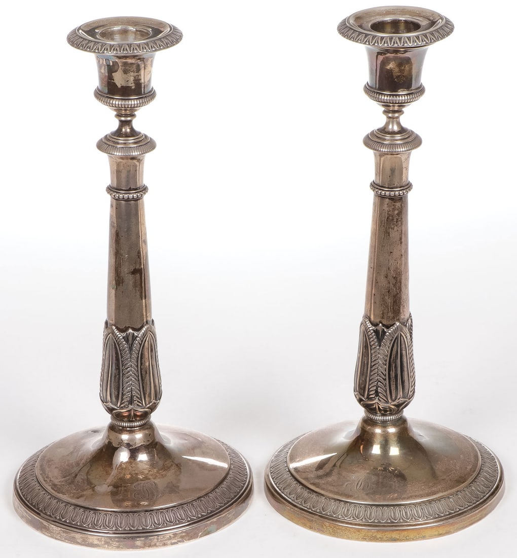 PAIR OF FRENCH SILVER CANDLESTICKS, 19TH C: PAIR OF FRENCH SILVER CANDLESTICKS, 19TH C. Of classical form with leaftip banded base and tapering stem, French standard mark 1819-1838 and makers mark JGBA. Height 10.25 inches (26cm). Total weight 