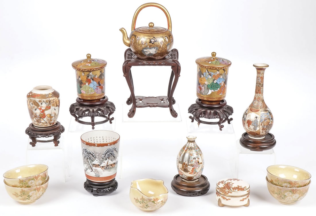 13 PCS JAPANESE SATSUMA WARE: 13 PCS JAPANESE SATSUMA WARE. Comprising a good group of 13 individual pieces of various shapes and forms, including a heavily gilded tea pot on carved wood stand, marked on underside of base, a pair 