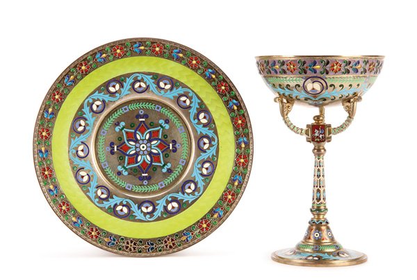 FANTASTIC RUSSIAN SILVER & ENAMEL SHERBERT, KHLEBNIKOV: AN IMPERIAL RUSSIAN SILVER PLIQUE-A-JOUR, GUILLOCHE AND CHAMPLEVÉ ENAMEL SHERBET CUP WITH MATCHING UNDERPLATE, KHLEBNIKOV, MOSCOW, 1899-1907. Rising from a cone form foot, the tapering central stem s