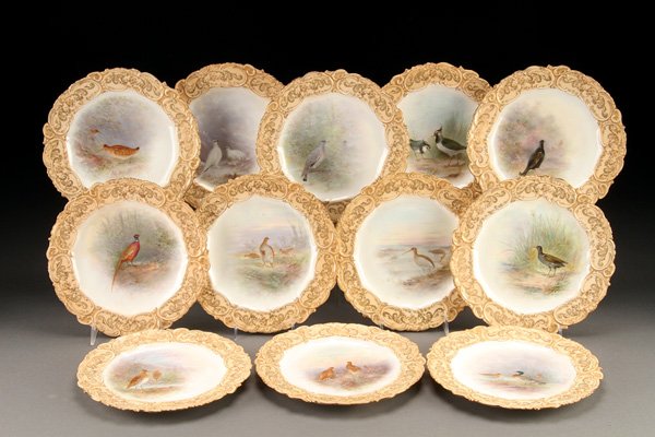 ORNITHOLOGICAL CABINET PLATES, TIFFANY & CO.: A SET OF TWELVE DOULTON BURSLEM FOR TIFFANY & COMPANY HANDPAINTED PORCELAIN ORNITHOLOGICAL CABINET PLATES, CIRCA 1900. Each finely painted by Mary Mitchell within embossed enameled and gilt scrolled r