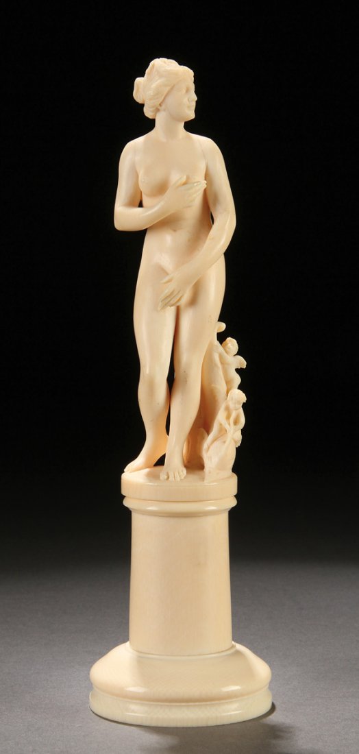 A FRENCH CARVED IVORY FIGURE, "MEDICI VENUS": A GOOD FRENCH CARVED IVORY FIGURE OF "MEDICI VENUS", 19TH CENTURY, PROBABLY DIEPPE. After the antique. Depicted in good form standing beside a dolphin surmounted with two winged putti. Raised on a tap