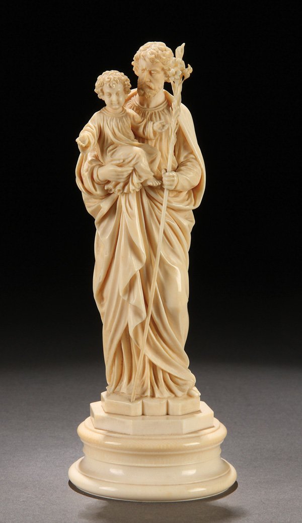 A GERMAN IVORY CARVED FIGURE OF JOSEPH & CHRIST: A VERY FINE GERMAN IVORY CARVED FIGURE OF JOSEPH AND THE INFANT CHRIST, LATE 19TH CENTURY. Finely carved with good anatomy and deeply recessed folds in garments. Depicting a standing form of Joseph wi