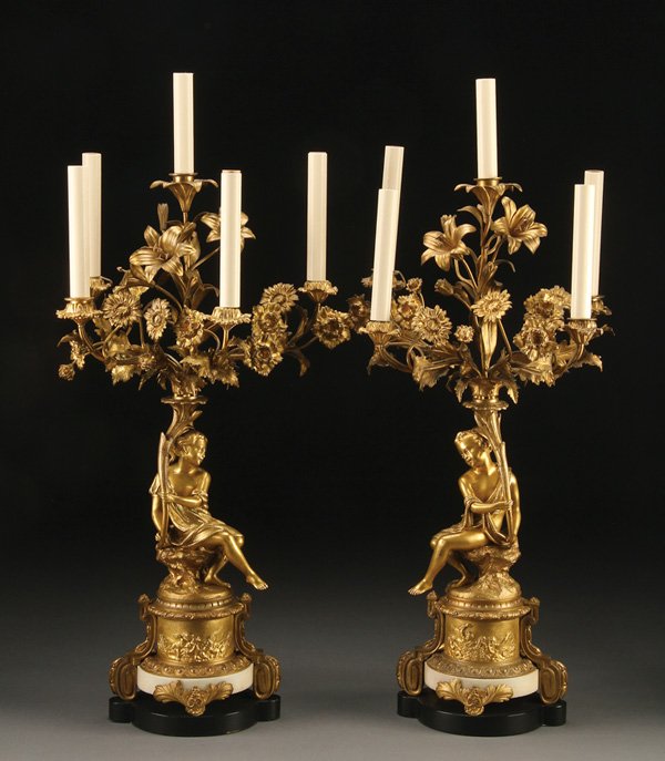 FRENCH BRONZE & ALABASTER CANDELABRA: A PAIR OF FRENCH NEOCLASSIC STYLE GILT BRONZE AND ALABASTER CANDELABRA, 19TH CENTURY. Each in the form of a young boy and girl raised on circular bracketed plinth with embossed classical scenes of pl