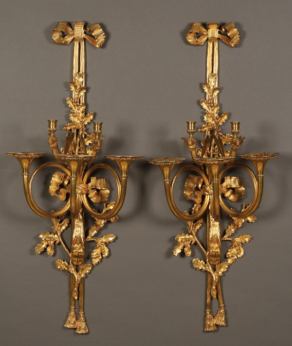 FRENCH SECOND EMPIRE GILT BRONZE WALL SCONCES: A PAIR OF LARGE AND IMPRESSIVE FRENCH SECOND EMPIRE GILT BRONZE WALL SCONCES, 19TH CENTURY. Each with two scrolled candle arms with sculpted camel head terminals and dragonfly wings above three coiled