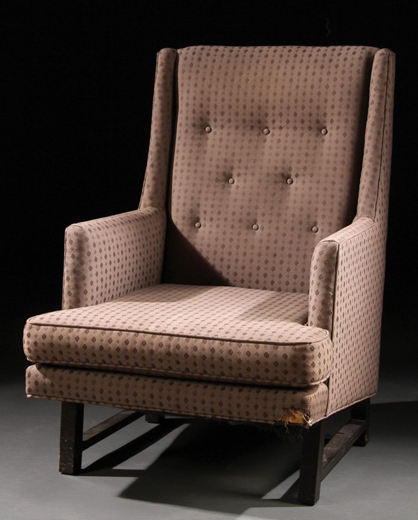 HIGH-BACK ARMCHAIR, EDWARD WORMLEY FOR DUNBAR: EDWARD WORMLEY FOR DUNBAR, HIGH-BACK ARMCHAIR, MID 20TH CENTURY. With tufted back and upholstered in tan patterned fabric on dark-stained legs.