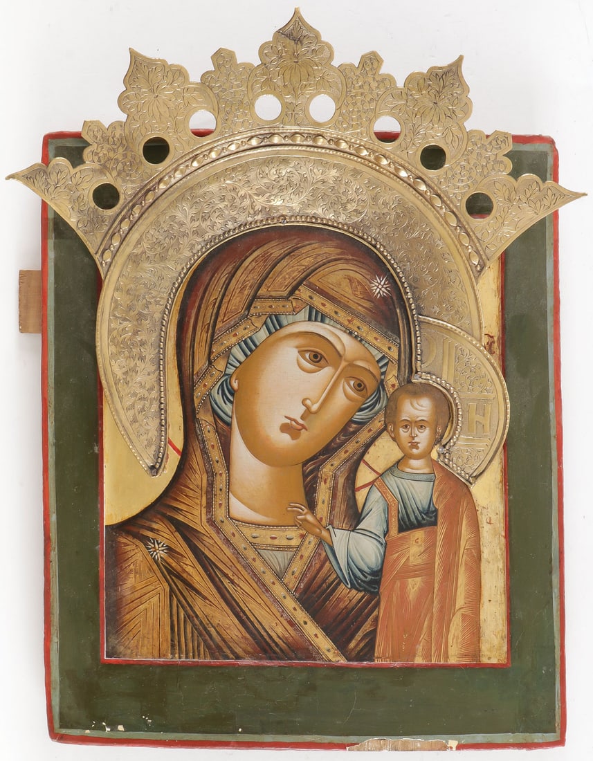 RUSSIAN ICON OF THE KAZAN MOTHER OF GOD: RUSSIAN ICON OF THE KAZAN MOTHER OF GOD. Comprising a finely painted icon with extensive chrysography, subtle shading, and jewel encrusted edging, and with an ornate applied chased gilt metal halo. 12