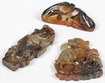 THREE CHINESE CARVED JADE PENDANTS