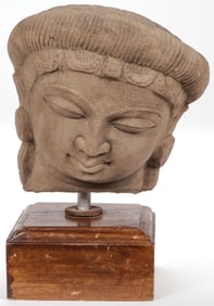 AN INDIAN CARVED SANDSTONE HEAD