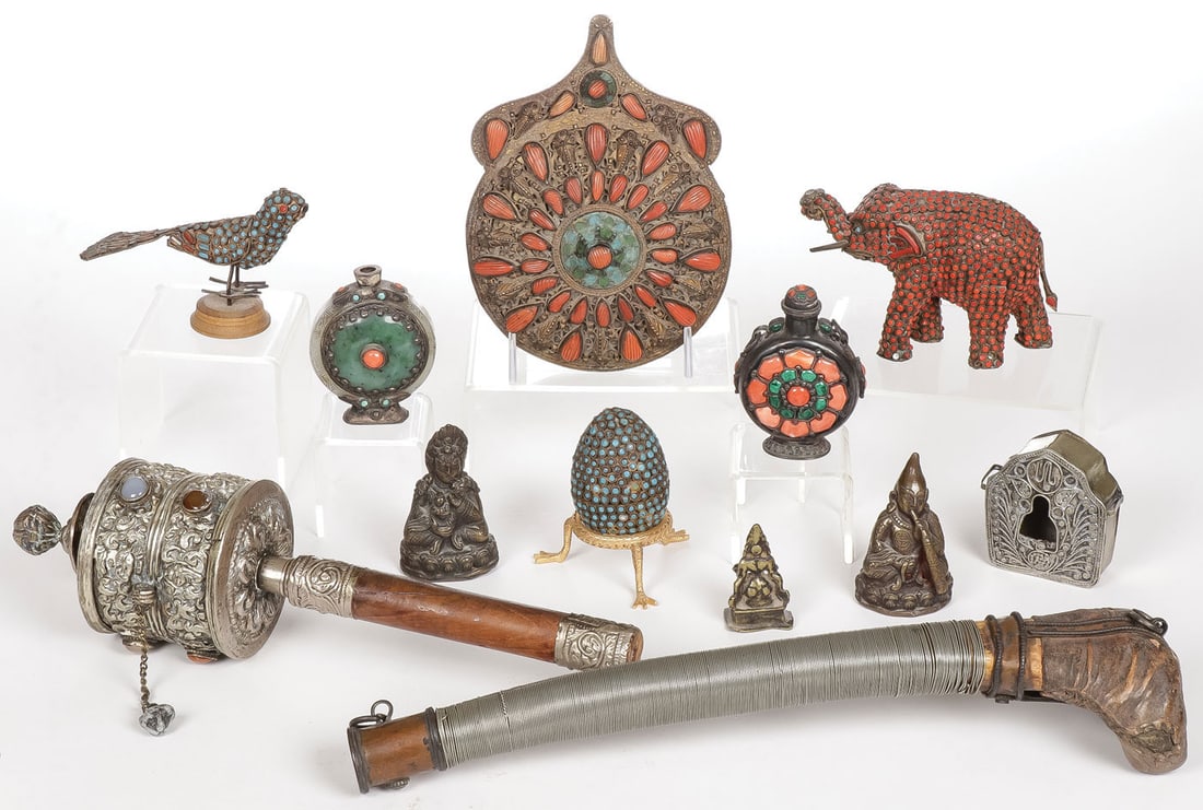 GROUP OF TIBETAN DECORATIVE ARTS: GROUP OF TIBETAN DECORATIVE ARTS. Comprising twelve individual pieces including a wire wrapped bone horn, a silver prayer wheel with cabochons, a turquoise and coral medallion, various animals, snuff 