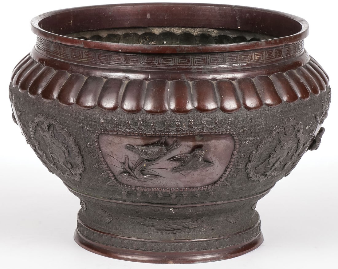 JAPANESE BRONZE JARDINIERE MEIJI: JAPANESE BRONZE JARDINIERE MEIJI. Finely sculpted, the sides banded with four reserves displaying songbirds, and interspersed with various mythological creatures, and the rim with Greek Key banded bor