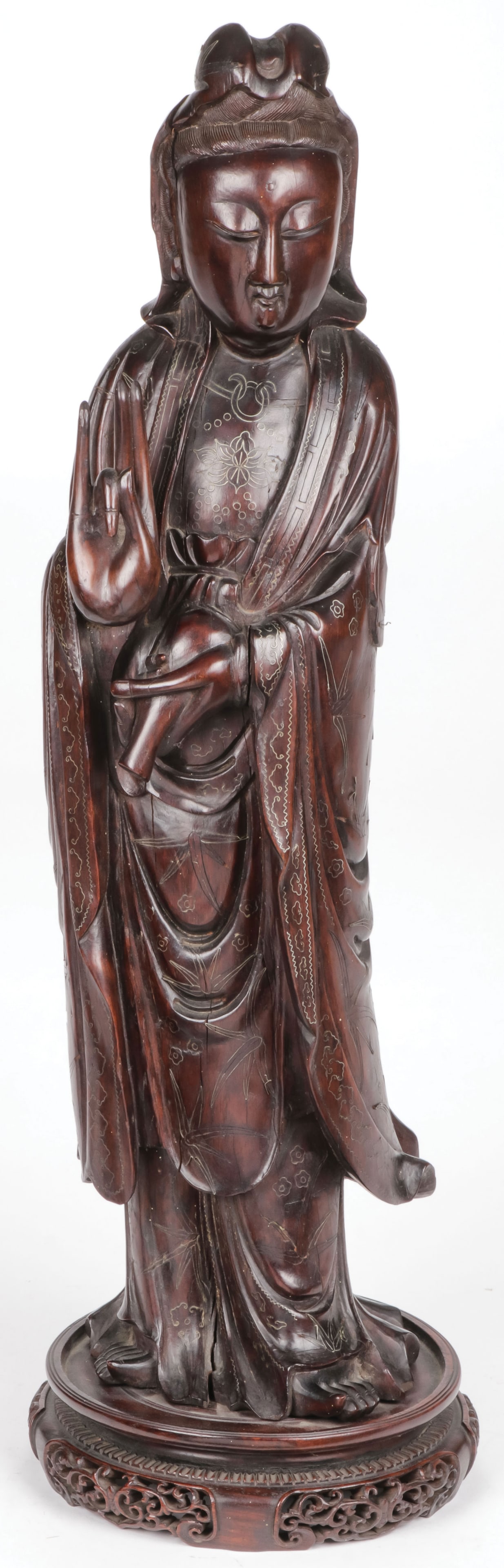 A FINE CHINESE CARVED GUANYIN QING DYNASTY: A FINE CHINESE CARVED GUANYIN QING DYNASTY. Sensitively carved in full round with deep folds of good proportions and her garments with wire inlaid decoration, set on a pierce carved base, height 24.5 