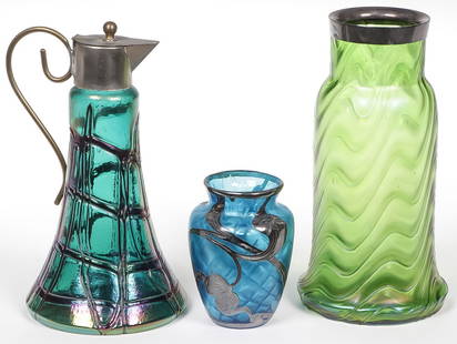 THREE AUSTRIAN/BOHEMIAN MOUNTED ART GLASS PIECES: THREE AUSTRIAN/BOHEMIAN MOUNTED ART GLASS PIECES. Comprising an iridescent wine or oil cruet, a blue MOP diamond quilted satin glass vase with Art Nouveau silver overlay flowers, and polished pontil.