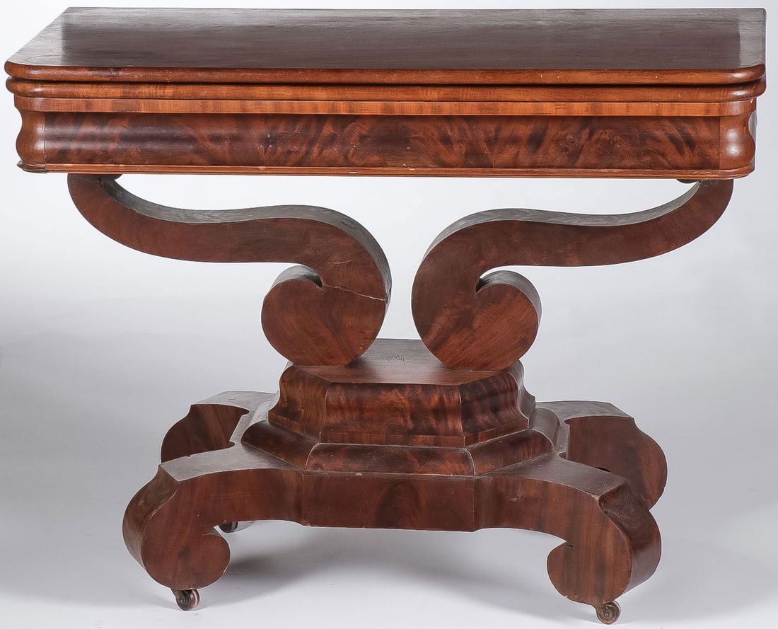 FLAME MAHOGANY EMPIRE GAME TABLE: FLAME MAHOGANY EMPIRE GAME TABLE. With scroll feet and fold out top and velvet lined interior reserve. Height 28.5 inches, width 37 inches, depth 18.5 inches. NO RESERVE. LOCAL PICK-UP OR 3RD PARTY SH
