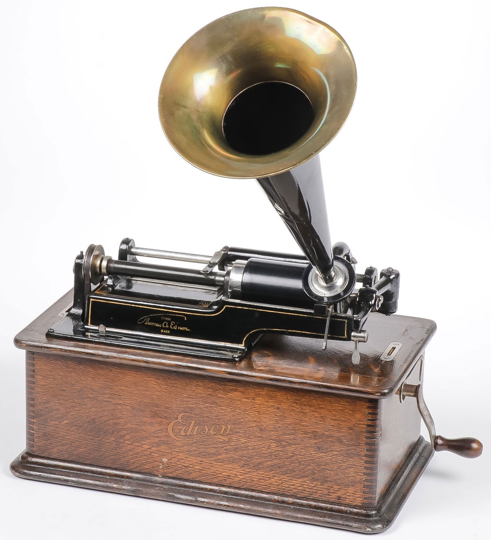 EDISON PHONOGRAPH & CYLINDER RECORDS: EDISON PHONOGRAPH & CYLINDER RECORDS. Comprising an Edison Standard Model D phonograph, oak case, swivel carrying handle, tin and brass horn. Together with 38 cased cylinder records, as shown. NO RESE