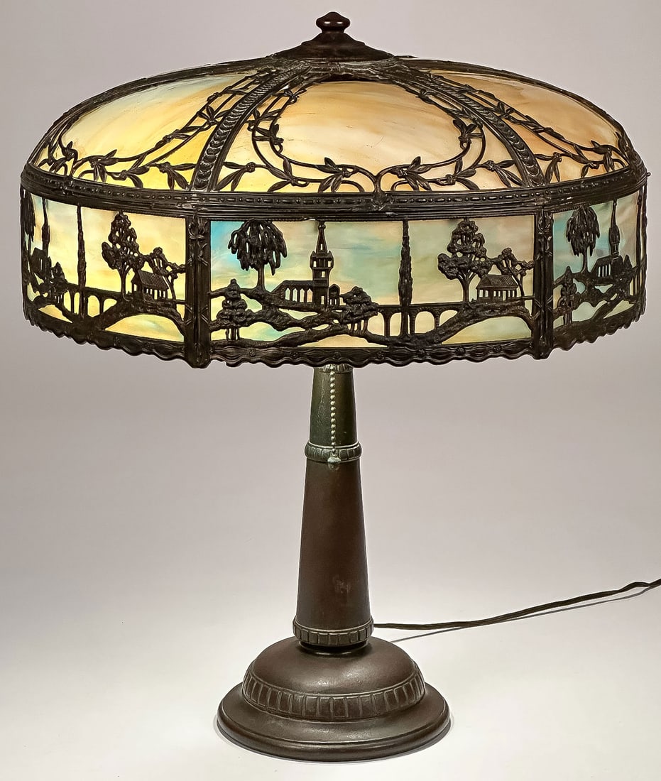 SLAG GLASS TABLE LAMP, C. 1915: SLAG GLASS TABLE LAMP, C. 1915. With silhouette frame and slag glass inserts, base with Handel cloth label. Diameter of shade 18 inches, overall height 21.5 inches. NO RESERVE. Provenance: From the e