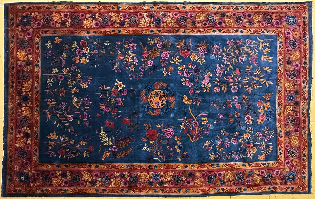 PALACE SIZE CHINESE ART DECO CARPET, C. 1930: PALACE SIZE CHINESE ART DECO CARPET, C. 1930. Comprising a large and impressive room or palace size carpet with dark blue field decorated with flowers and brick red floral decorated borders. Size: 18 