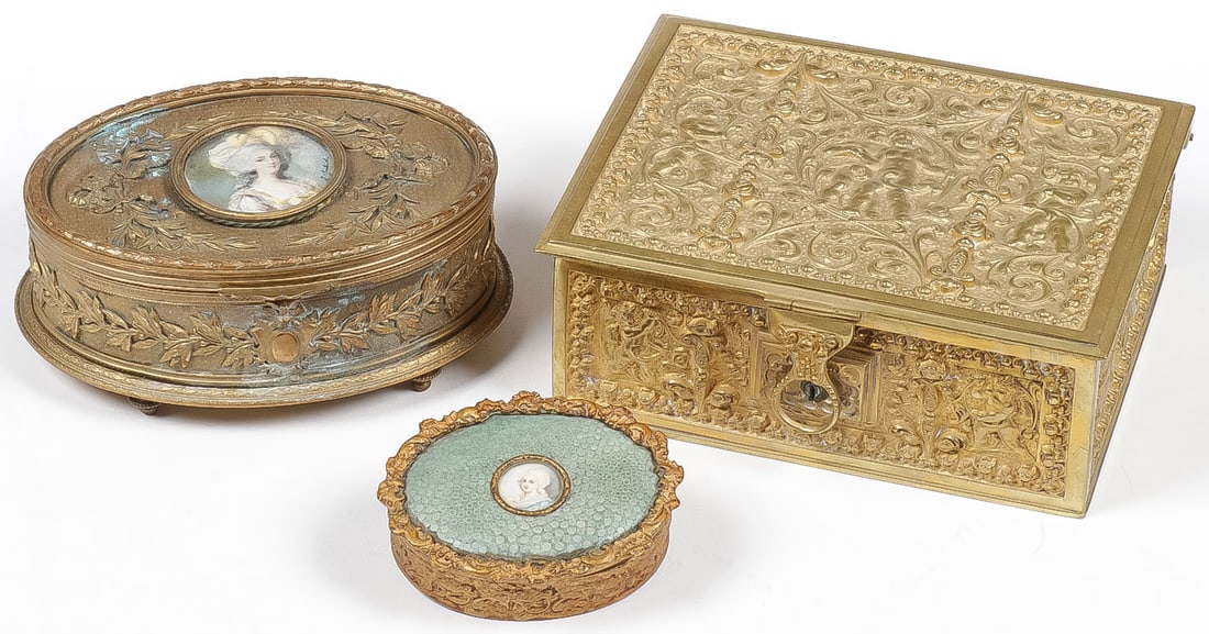 THREE GILT METAL JEWELRY BOXES: THREE GILT METAL JEWELRY BOXES. Comprising three good vintage gilt metal jewelry boxes, including an ornate oval musical example on bun feet the hinged lid with signed hand-painted miniature portrait,