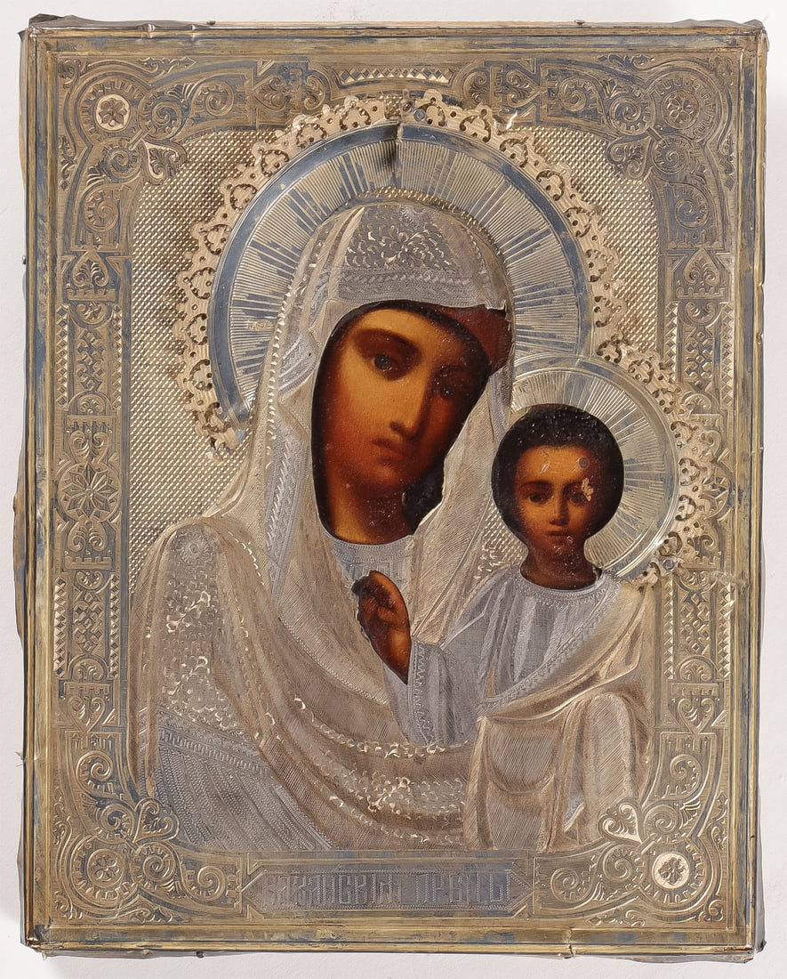 RUSSIAN ICON OF THE KAZANSKAYA, C 1890: RUSSIAN ICON OF THE KAZANSKAYA, C 1890. Overlayed with a heavily engraved silver gilt oklad hallmarked Moscow circa 1890 and indistinguishable Cyrillic makers mark. 8.75 inches x 7 inches (22.3cm x 17