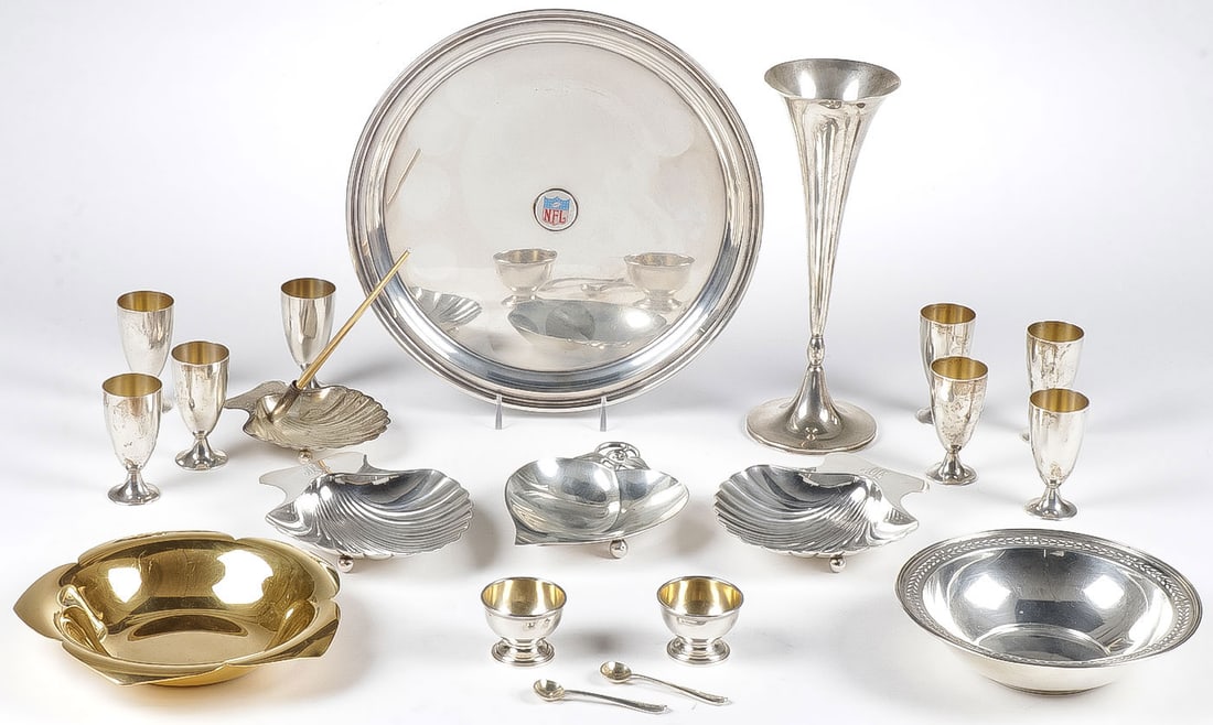 20 PCS TIFFANY STERLING: 20 PCS TIFFANY STERLING. Comprising a pair of matching shell-form nut dishes on ball feet, a leaf form nut dish, a shell form pen holder and gilt Tiffany pen, two additional bowls, one gilded, an NFL 