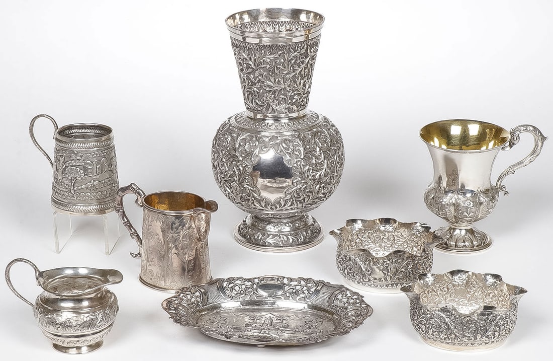 ASIAN/INDIAN SILVER GROUP: ASIAN/INDIAN SILVER GROUP. Comprising 8 individual pieces, some with stamped marks others unmarked, including a large heavily repoussed? bulbous vase (back row center), a handled cup (top left), and f