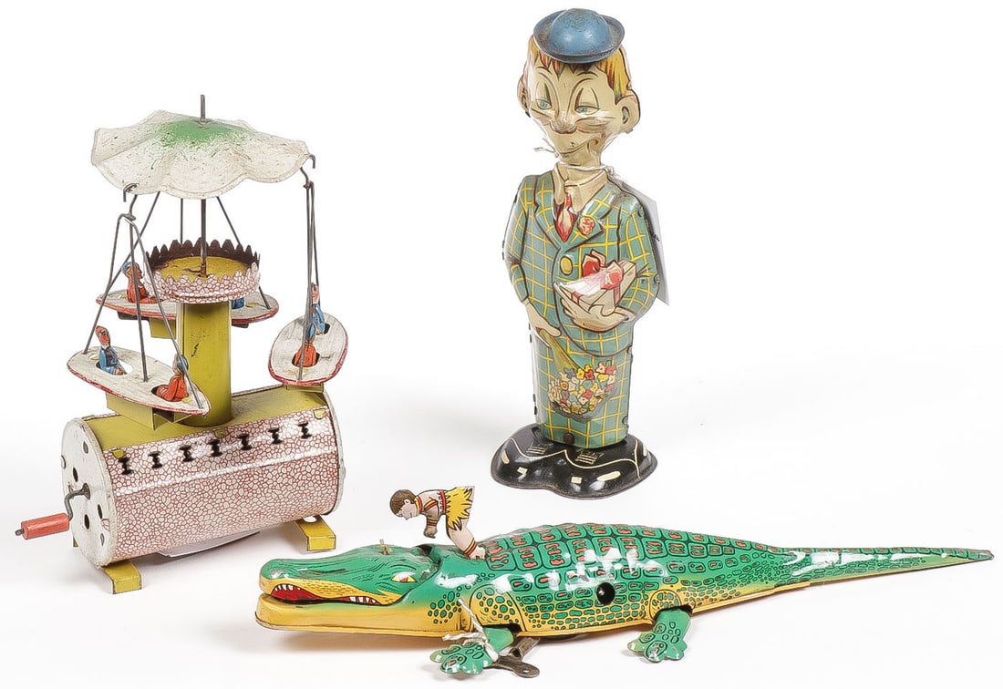 3 VINTAGE TIN WIND TOYS: 3 VINTAGE TIN WIND TOYS. Comprising a German tin litho wind musical carousel, a MARX tin wind up Mortimer Snerd walker (runs), and a Jungle Boy and Croc key tin wind up (takes wind and runs), length 1