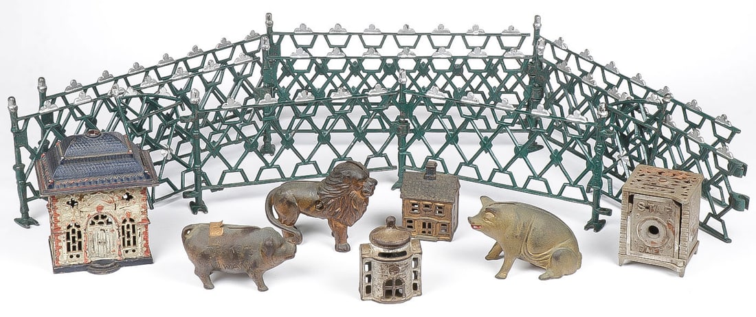 MIXED VINTAGE CAST IRON TOY GROUP: MIXED VINTAGE CAST IRON TOY GROUP. Comprising 8 pieces of cast iron doll house fence with gate, a cast iron still bank in form of bank building (disassembled), a cast iron still lion bank, a Decker's