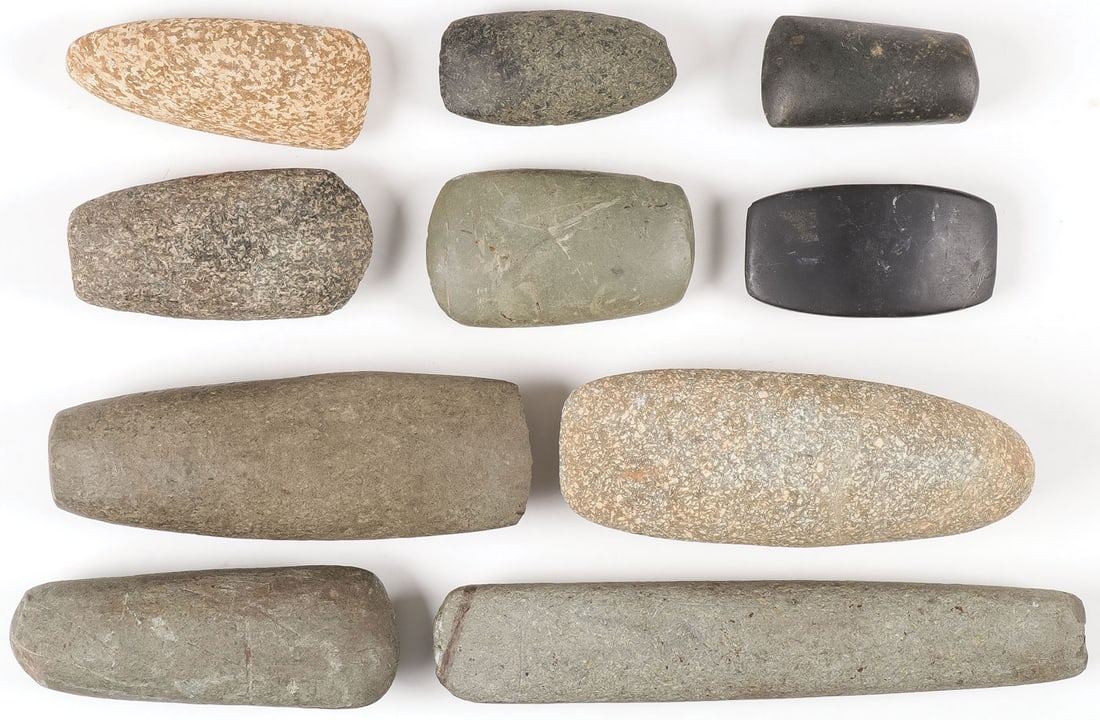 NINE STONE CELTS: NINE STONE CELTS. Various shapes, sizes, and materials as shown, as well as a polished slate axe head. Greatest length 9.75 inches. NO RESERVE. SHIPPING NOTICE: Except for large, oversized items, Jack