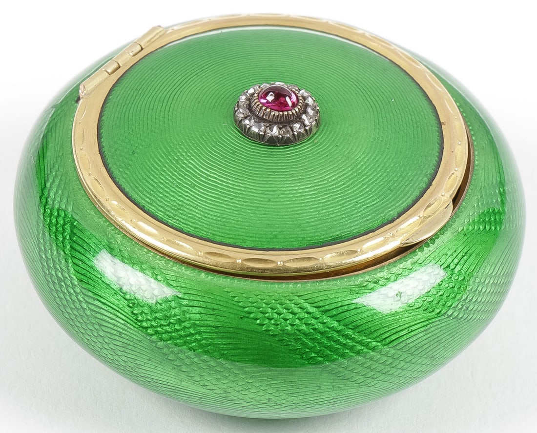 FABERGÉ SILVER-GILT ENAMELED PILL BOX: FABERGÉ SILVER-GILT ENAMELED PILL BOX ST. PETERSBURG 1896-1908. Of circular cushion form, overall in translucent green enamel over a guilloche ground the hinged lid centered with red cabochon enc