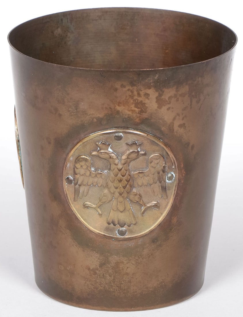 FABERGÉ EMPRESS ALEXANDRA WWI BEAKER: FABERGÉ EMPRESS ALEXANDRA WWI BEAKER TSARSKOE SELO 1916. Comprising a rare Russian Imperial presentation copper and brass World War I beaker by FABERGÉ. It is believed that these “austerity”