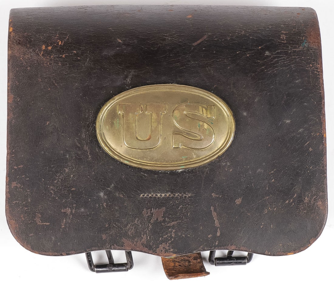 RARE M1868 US LEATHER CARTRIDGE BOX: RARE M1868 US LEATHER CARTRIDGE BOX. With leather scalloped front flap, mounted with an oval US plate, the interior with double flaps covering a wood block insert drilled on each side for 20 rounds (h