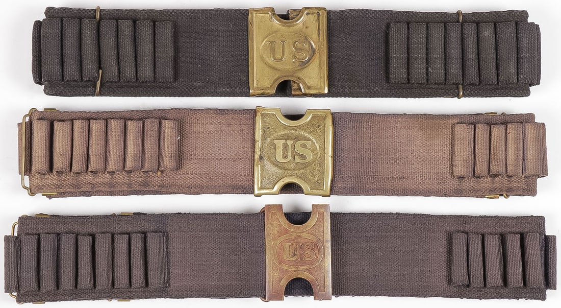THREE BLUE SPAN-AM 45/70 CARTRIDGE BELTS: THREE BLUE SPAN-AM 45/70 CARTRIDGE BELTS. Comprising three individual belts, all with variations of the "H" style US brass belt plate, the top example marked Mills. All in very good condition.