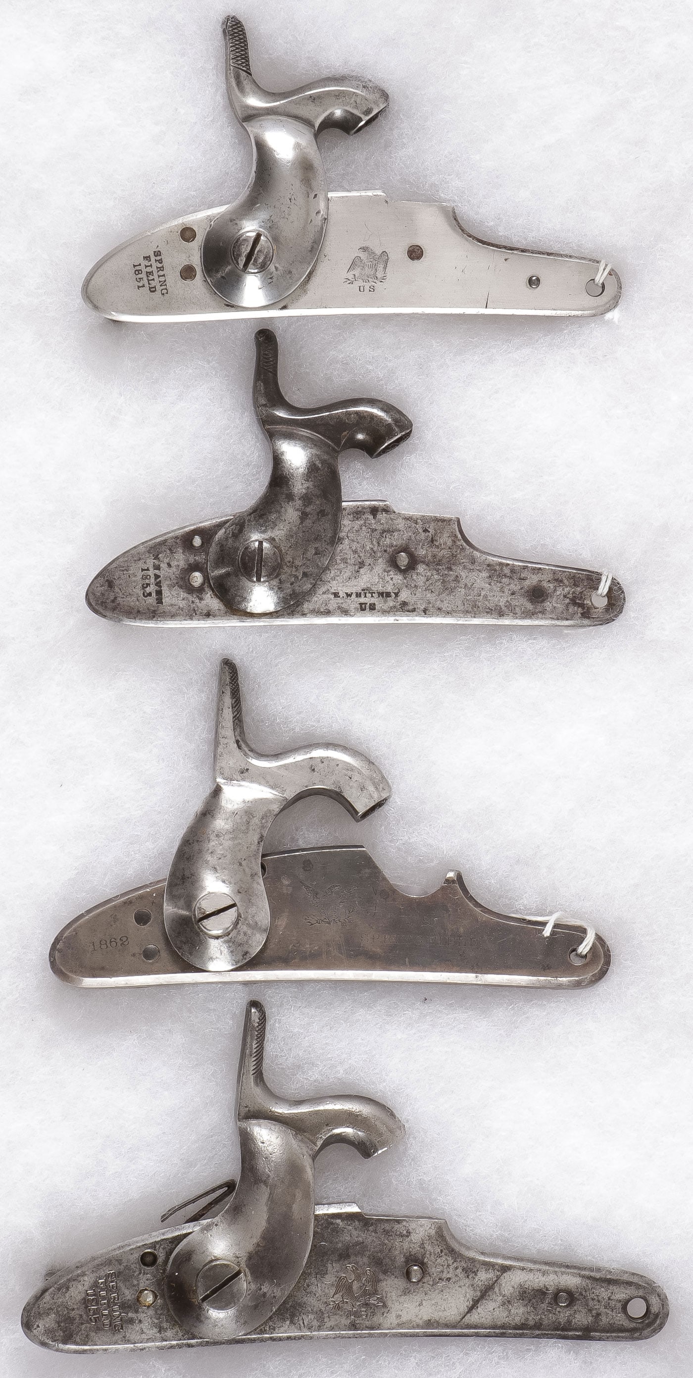 SPRINGFIELD AND WHITNEY LOCK & HAMMER PLATES: SPRINGFIELD AND WHITNEY LOCK & HAMMER PLATES. Comprising four lock and hammer plates including three Springfield marked examples, each with U.S. Eagle and various dates, 1851, 1855, 1862. And an E. Wh