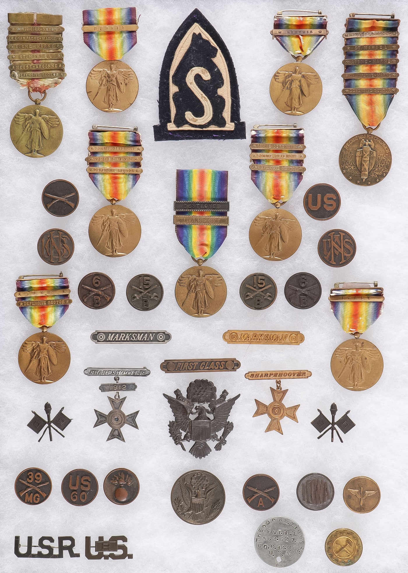 U.S. WWI MEDALS AND INSIGNIA GROUP: U.S. WWI MEDALS AND INSIGNIA GROUP. Comprising over 40 individual pieces including 9 WWI Victory Medals with various bars, one with 6 bars including the less common MONTDIDIER-NOYON bar, as well as ot