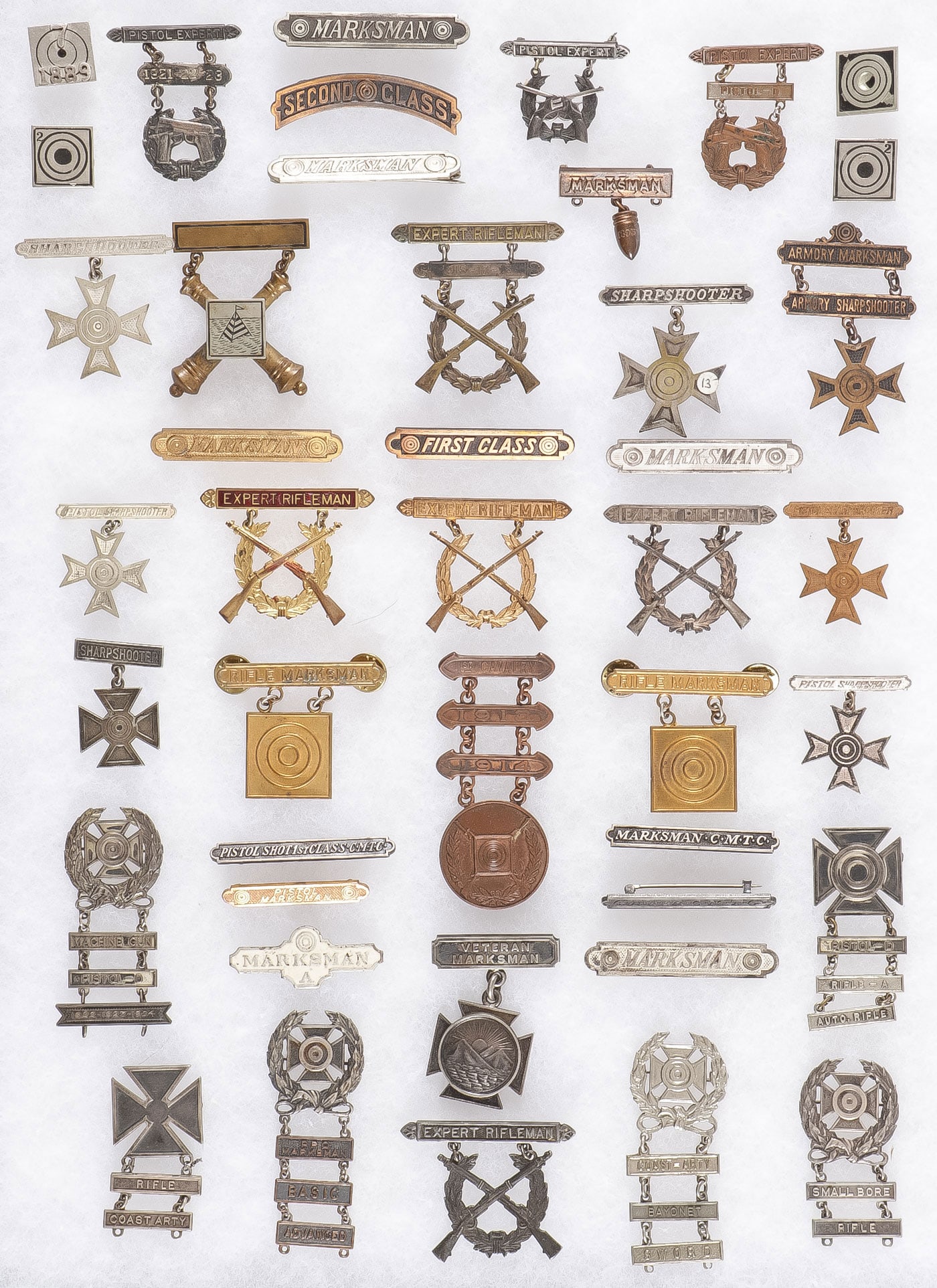 GREAT U.S. VINTAGE MARKSMANSHIP BADGES: GREAT U.S. VINTAGE MARKSMANSHIP BADGES C. 1880-1945. Comprising a collection of 47 various U.S. marksmanship qualification badges including six early button types, one dated 1889, as well as other var