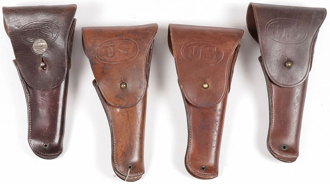 4 U.S. ARMY WWI M1916 LEATHER HOLSTERS: 4 U.S. ARMY WWI M1916 LEATHER HOLSTERS FOR THE 1911. Comprising four good leather holsters, the flap of each with US oval stamp, one with transitional infantry collar disc, one dated 1917, two dated 1