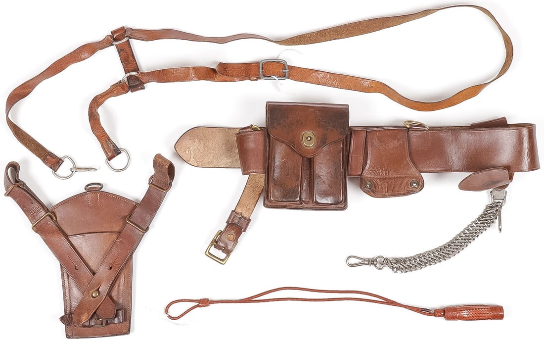WWI SAM BROWNE BELT & ACCESSORIES: WWI SAM BROWNE BELT & ACCESSORIES. Comprising a Sam Browne belt with French nickel plated sword hanger, leather pouch for two 1911 magazines, as well as a early pattern sword frog, a leather shoulder 