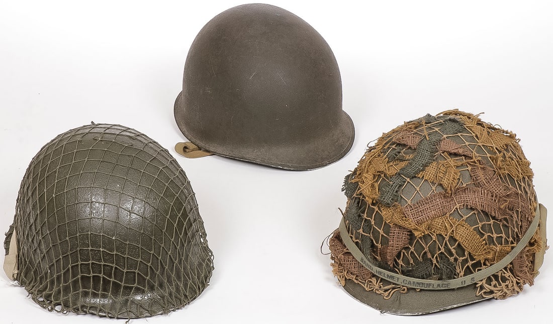 THREE US M1 FRONT SEAM HELMETS: THREE US M1 FRONT SEAM HELMETS. Comprising a Schlueter-made front-seam M1 helmet with swivel bales and khaki strap, circa 1944, with Westinghouse liner. The liner repainted and with 40th Armor decals,