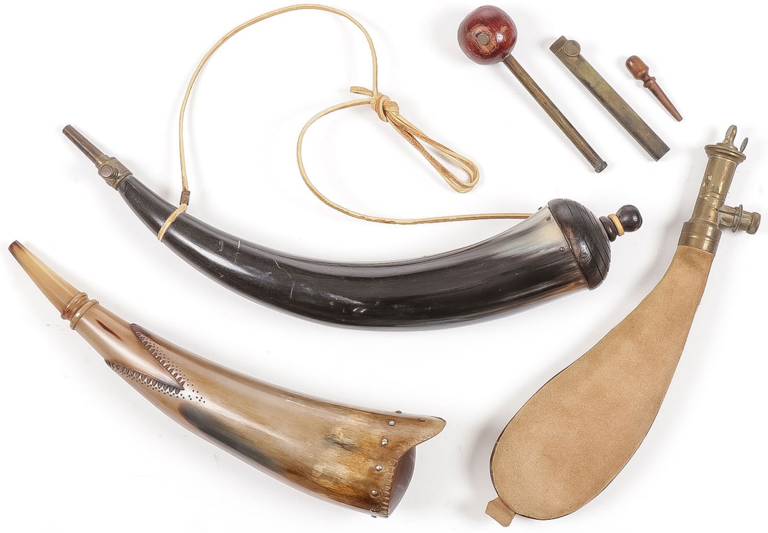 2 POWDER HORNS AND SHOT BAG: 2 POWDER HORNS AND SHOT BAG. Comprising two cow horn powder horns, one with carving (chipped spout) and the other with brass spout and strap. Together with a leather shot bag with brass measuring spou