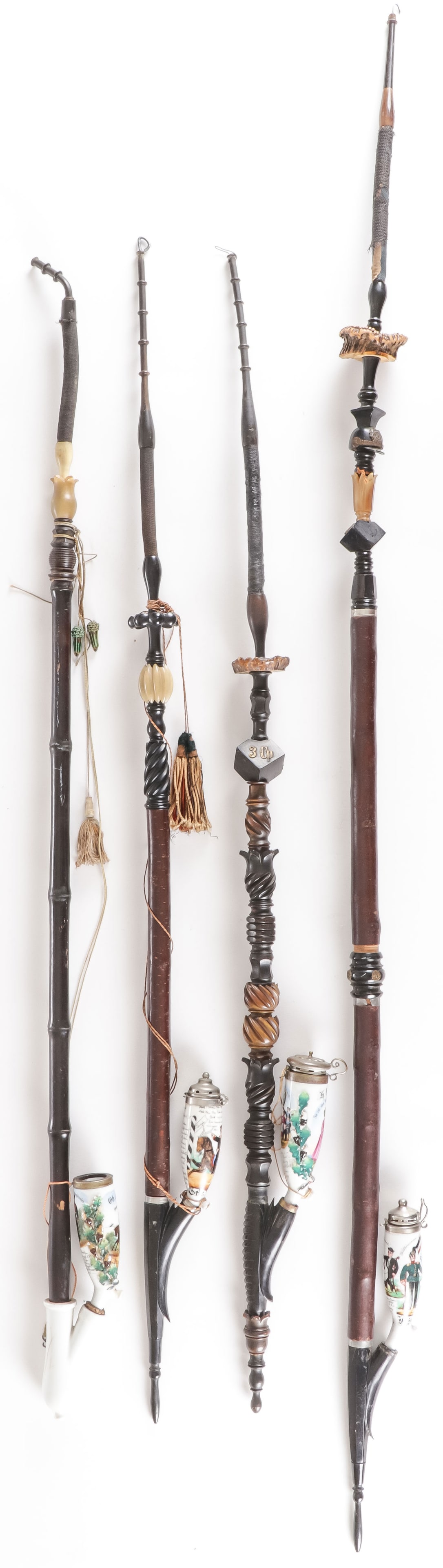 4 ORNATE IMPERIAL GERMAN RESERVIST PIPES: 4 ORNATE IMPERIAL GERMAN RESERVIST PIPES. Each with carved horn and wood stems, two with tassels, each with hand painted bowls two with molded relief oak leaf wreaths. One in memory of 3rd Troop, 1st