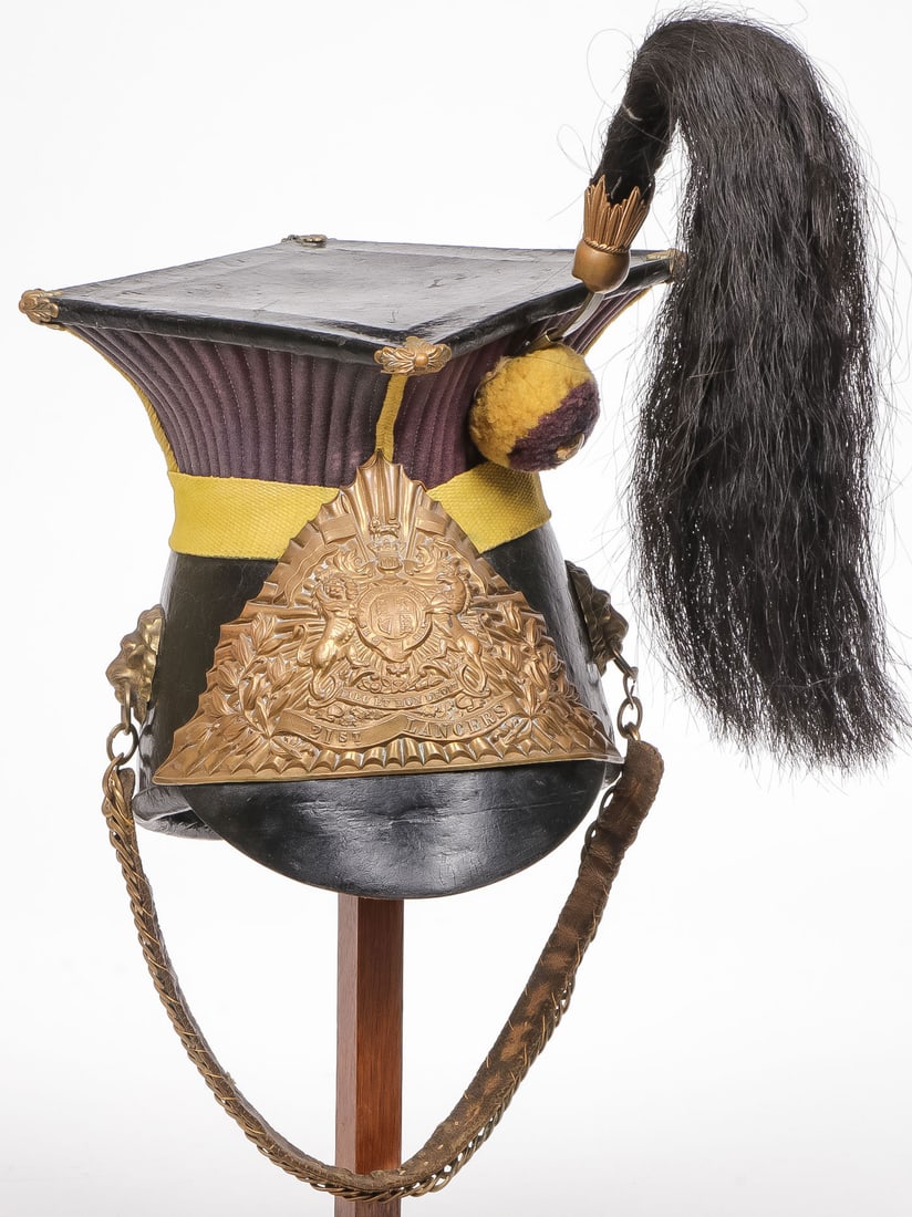 GOOD BRITISH 21ST LANCERS OTHER RANKS CAP: GOOD BRITISH 21ST LANCERS OTHER RANKS CAP. Comprising a good solid chapka, the skull, peak and top of the mortar board are in black patent leather. The corners of the mortar board with gilt brass flor