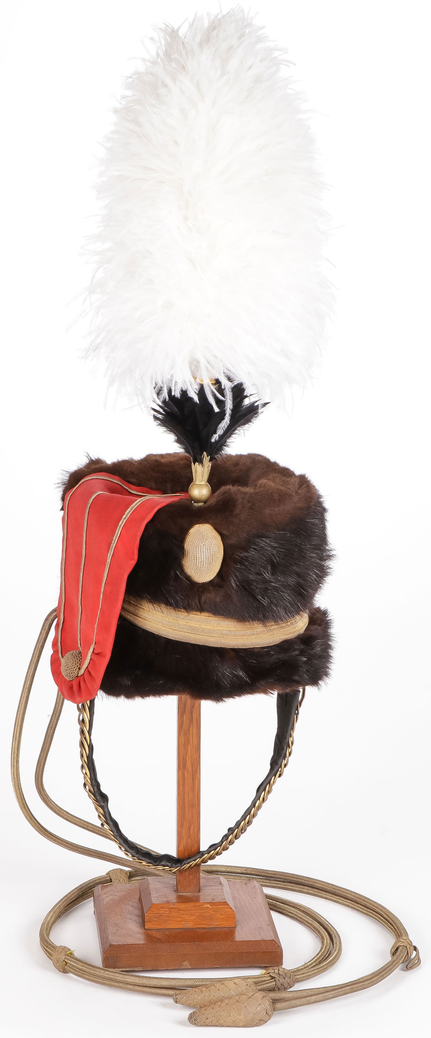 NAMED BRITISH 10TH HUSSARS FUR BUSBY, C. 1887: NAMED BRITISH 10TH HUSSARS FUR BUSBY, C. 1887. Comprising a fine British 10th Hussars Prince of Wales Own busby. The bear fur body affixed with bullion cord, red felt gilt piped bag, bullion cockade w