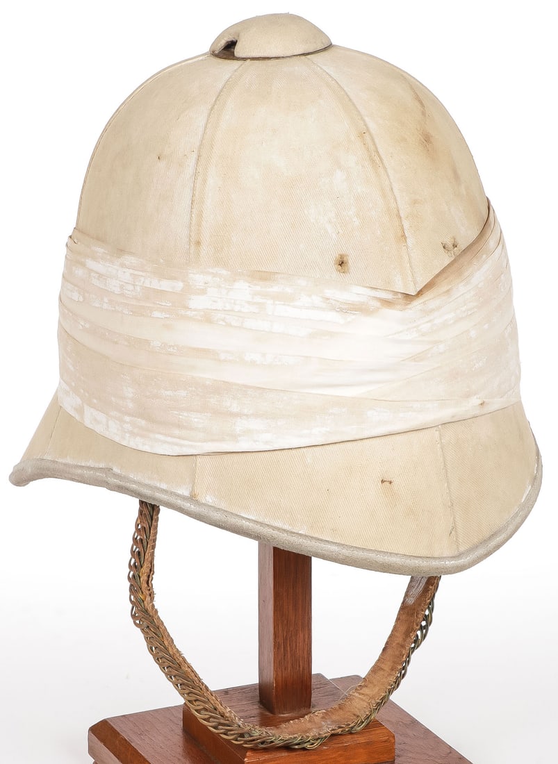 BOER WAR 2ND DRAGOON GUARDS PITH HELMET: BOER WAR 2ND DRAGOON GUARDS PITH HELMET. Cork body with traces of white paint over khaki covering and with buff leather rim, the left side of puggaree with felt embroidered 2nd Dragoon Guards flash, a
