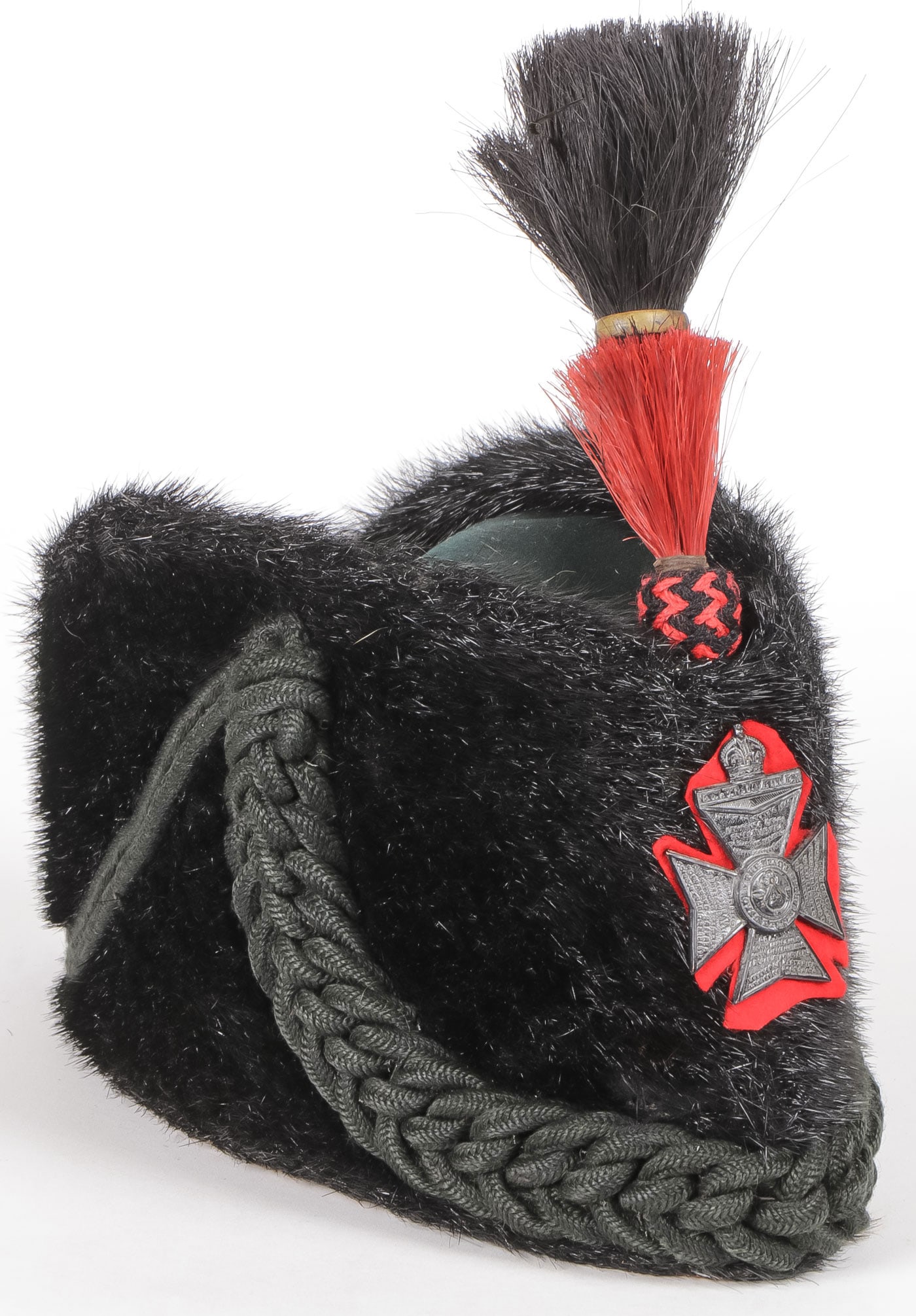 KING'S ROYAL RIFLE CORPS SEAL SKIN BUSBY C. 1900: A KING'S ROYAL RIFLE CORPS SEAL SKIN BUSBY C. 1900. A seal skin exterior, felt top with attached dark green braided cords. The front with King's Royal Rifle Corps badge on red felt cross and above on 