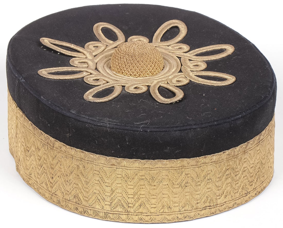 BRITISH ARTILLERY OFFICERS PILL BOX HAT C.1875: BRITISH ARTILLERY OFFICERS PILL BOX HAT C.1875. Dark navy blue wool body with bullion embroidered banding, gold braided top with dome. Original leather sweat band and quilted red silk lining with gilt
