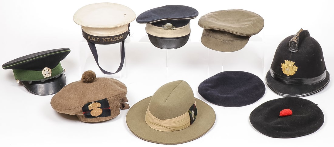 9 BRITISH MILITARY HATS C. 1900 - 1960: 9 BRITISH MILITARY HATS C. 1900 - 1960. Including a Royal Scots Fusiliers bonnet with regimental badge on tartan and dated 1945, a 17th/21st Lancer's visor cap, a genuine HMS NELSON Naval Cap, a good 