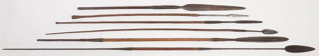 SEVEN AFRICAN SPEARS: SEVEN AFRICAN SPEARS. Six with forged metal tips and a few with spikes on opposite end of wooden shaft, and one wooden barbed spear, greatest length 84 inches.
