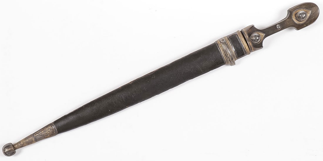 CAUCASIAN KINDJAL DAGGER WITH SILVER MOUNTS: CAUCASIAN KINDJAL DAGGER WITH SILVER MOUNTS, 19TH C. Of traditional form with flattened diamond shaped blade with four fullers, horn grip scales with leather covered wood scabbard, and overall with si