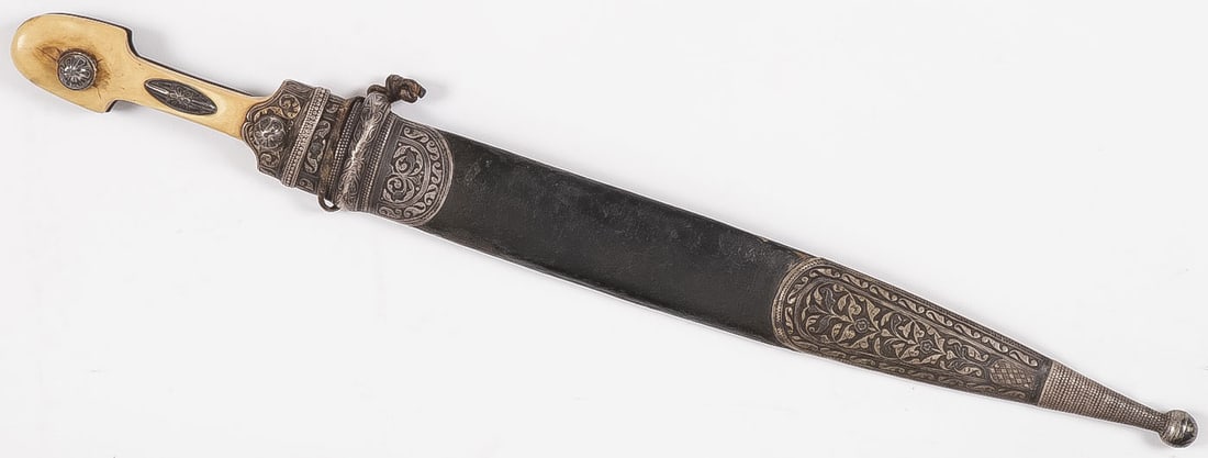 RUSSIAN/ CAUCASIAN KINDJAL W SILVER MOUNTS: RUSSIAN/ CAUCASIAN KINDJAL W SILVER MOUNTS, 19TH C. Of traditional form with flattened diamond shaped blade with four fullers, horn and polished bone grip scales with leather covered wood scabbard, an